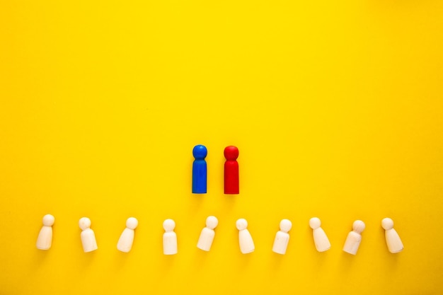 Concept of supremacy leader wooden figures on yellow background