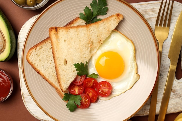 Concept of tasty breakfast on brown background