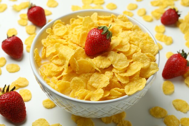 Concept of tasty breakfast with cornflakes and strawberry on white