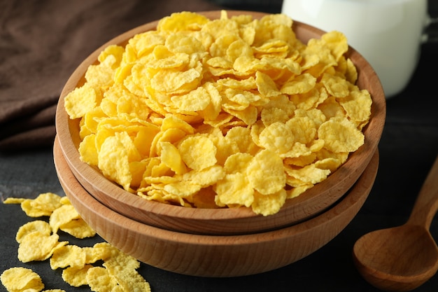 Concept of tasty breakfast with cornflakes on wooden table