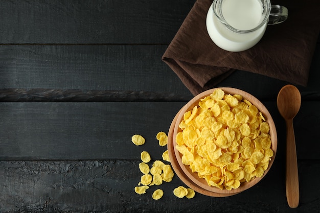 Concept of tasty breakfast with cornflakes on wooden table