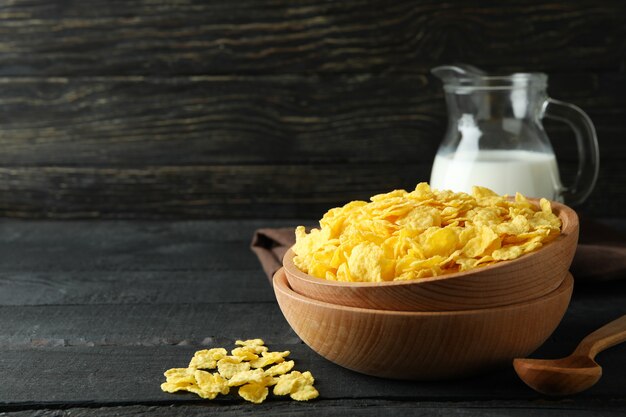 Concept of tasty breakfast with cornflakes on wooden table