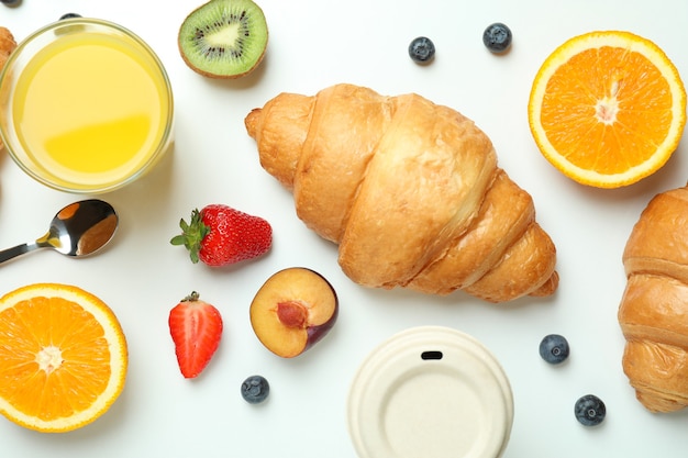 Concept of tasty breakfast with croissants on white