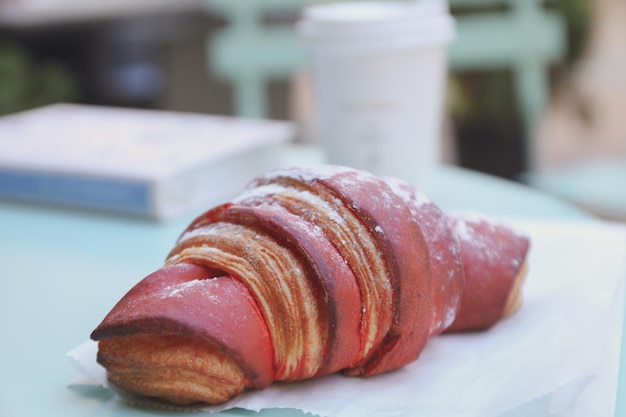 Concept of tasty breakfast with cup of coffee and croissant