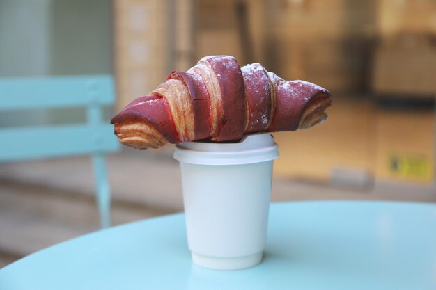 Concept of tasty breakfast with cup of coffee and croissant