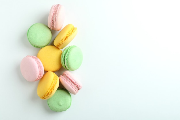 Concept of tasty dessert with macaroons on white background