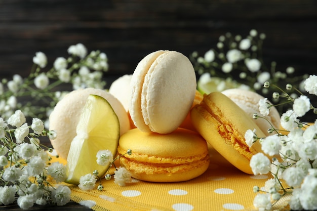 Concept of tasty dessert with macaroons on wooden background