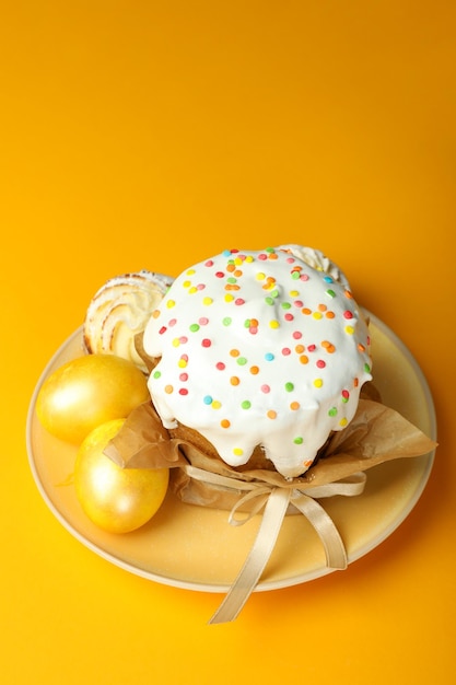 Concept of tasty Easter food on orange background