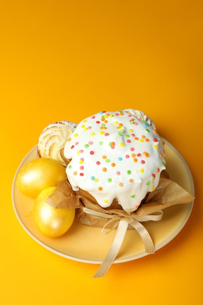 Concept of tasty Easter food on orange background