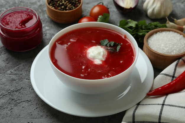 Concept of tasty eating with borscht on gray wall