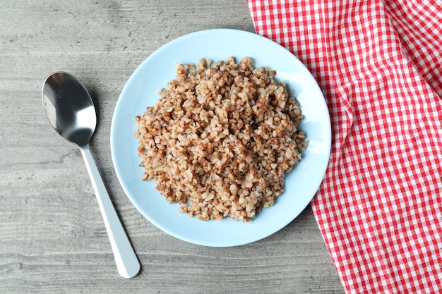 Concept of tasty eating with buckwheat on gray table