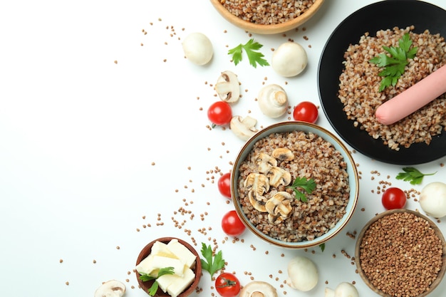 Concept of tasty eating with buckwheat on white background