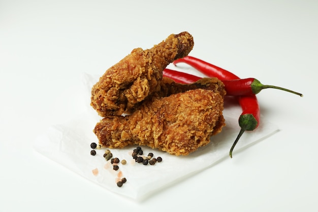 Concept of tasty eating with fried chicken on white background