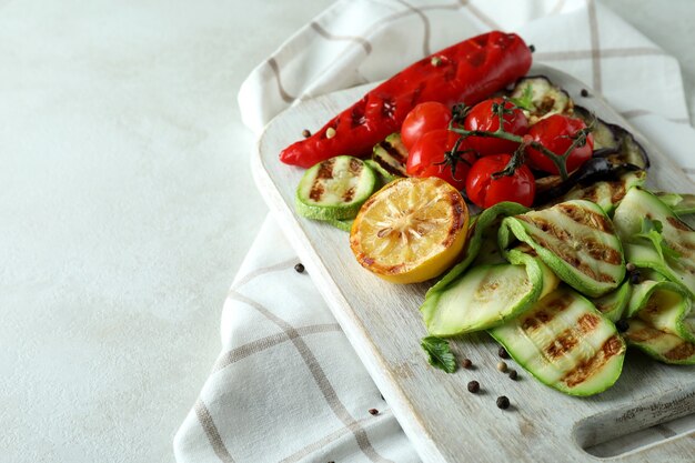 Concept of tasty eating with grilled vegetables on white textured table