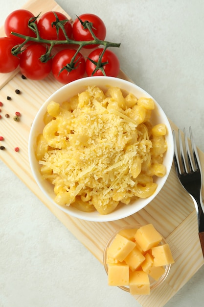 Concept of tasty eating with macaroni with cheese on white\
textured table