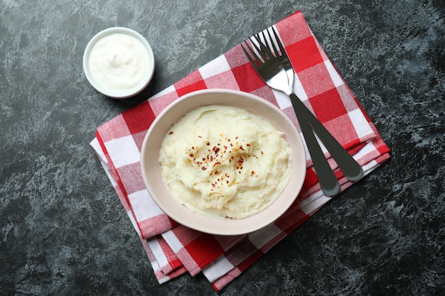 Concept of tasty eating with mashed potatoes on black smokey table