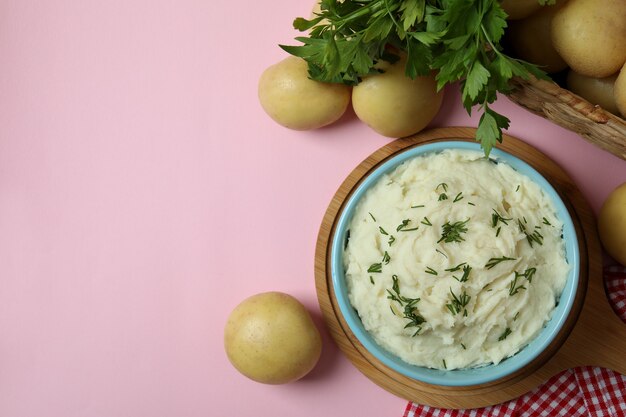 Concept of tasty eating with mashed potatoes on pink