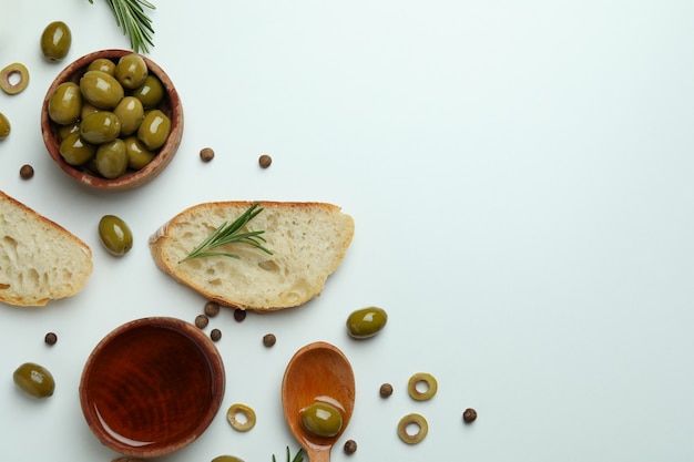 Concept of tasty eating with olive oil on white