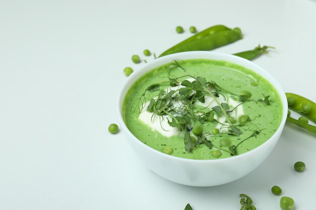 Concept of tasty eating with pea soup on white surface