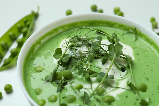 Concept of tasty eating with pea soup on white surface