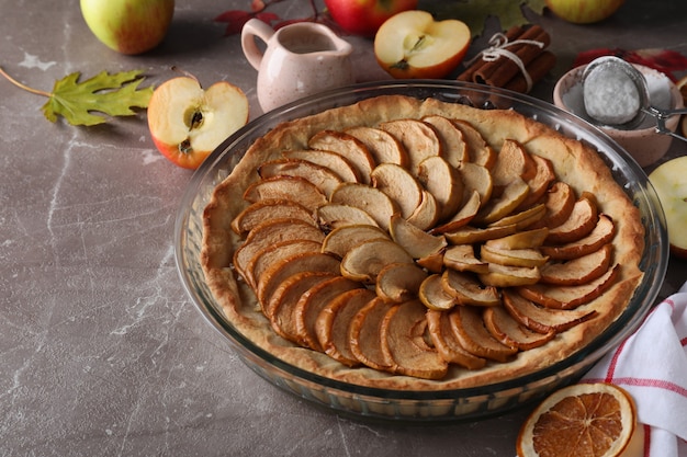 Concept of tasty food with apple pie on textured background