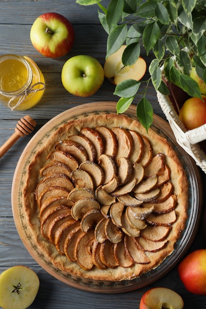 Concept of tasty food with apple pie on wooden background