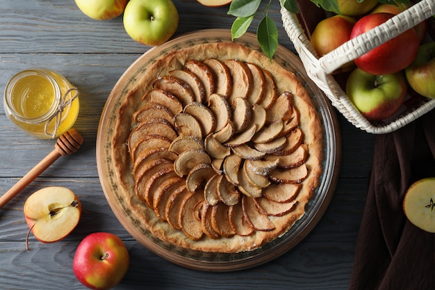 Concept of tasty food with apple pie on wooden background