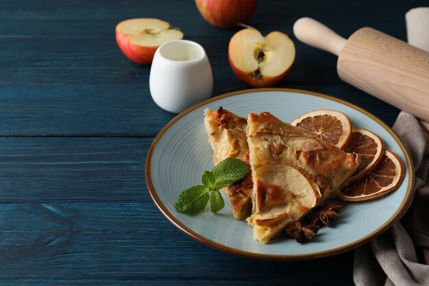 Concept of tasty food with apple pie on wooden background