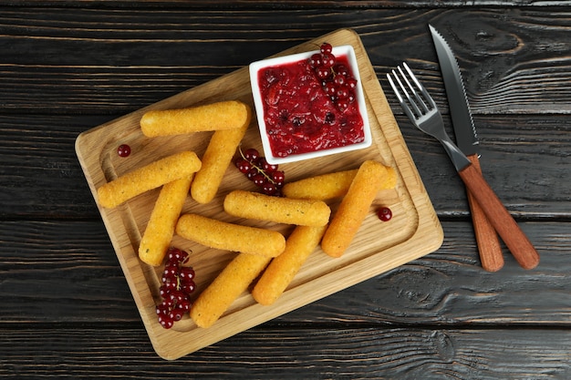 Concept of tasty food with cheese sticks on rustic wooden table