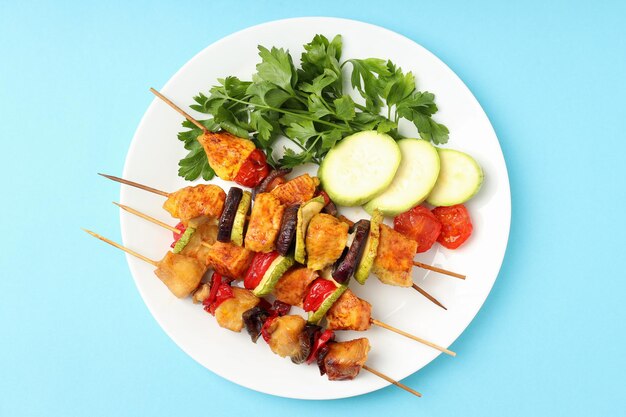 Concept of tasty food with chicken shashlik on blue background