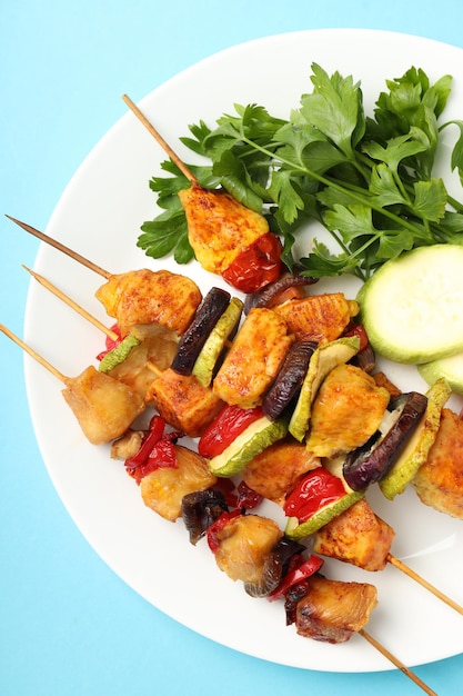 Concept of tasty food with chicken shashlik on blue background