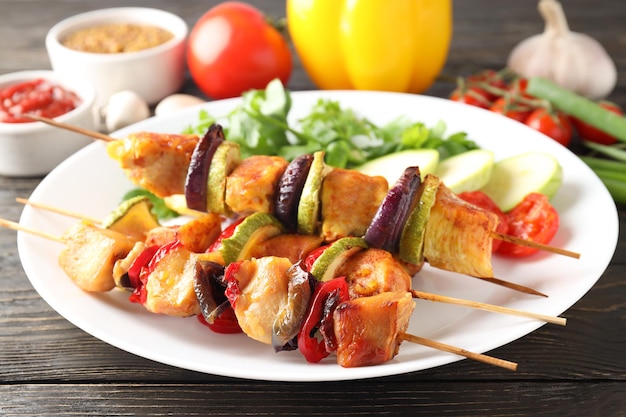 Concept of tasty food with chicken shashlik on dark wooden background