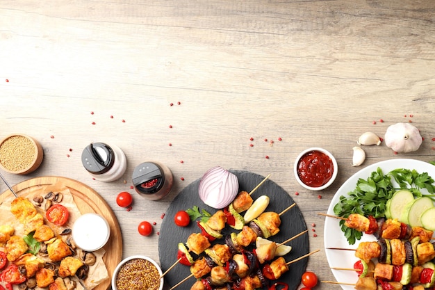 Concept of tasty food with chicken shashlik on light wooden background