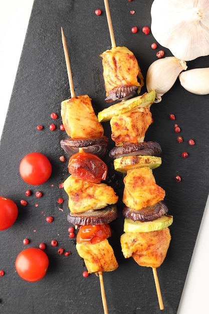 Concept of tasty food with chicken shashlik on white background