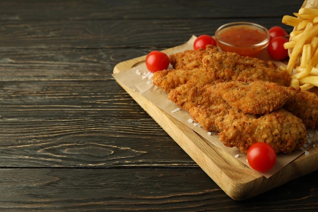 Concept of tasty food with chicken strips space for text