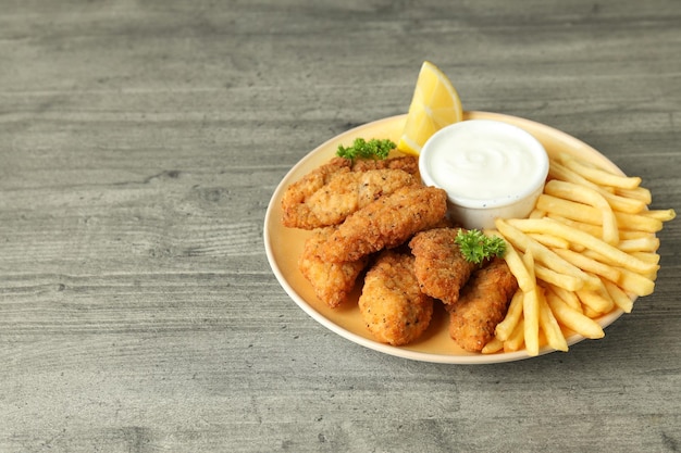 Concept of tasty food with chicken strips space for text