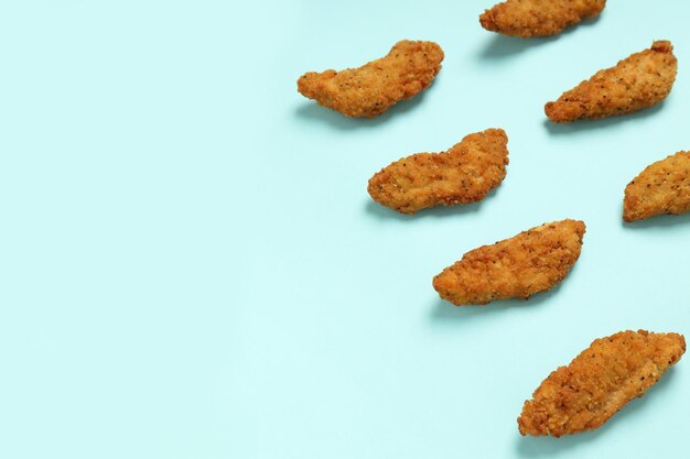 Concept of tasty food with chicken strips space for text