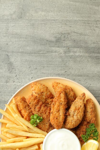 Concept of tasty food with chicken strips space for text