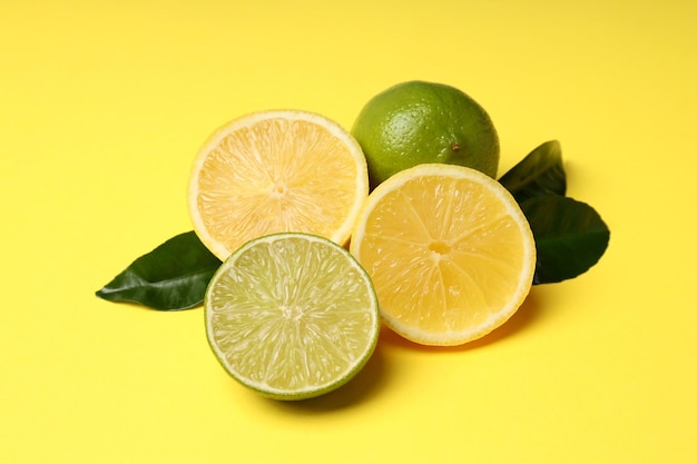 Concept of tasty food with citrus fruits on yellow background