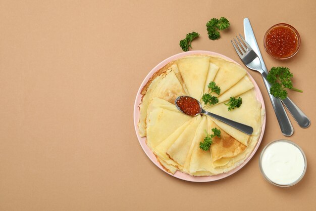 Concept of tasty food with crepes on beige background