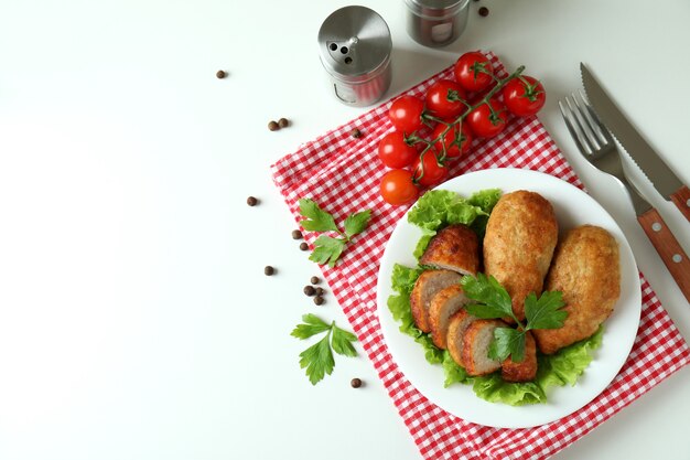 Concept of tasty food with cutlets on white background