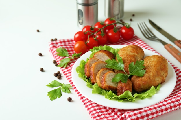 Concept of tasty food with cutlets on white background