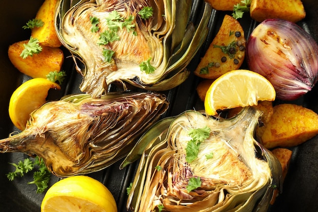 Concept of tasty food with grilled artichoke close up