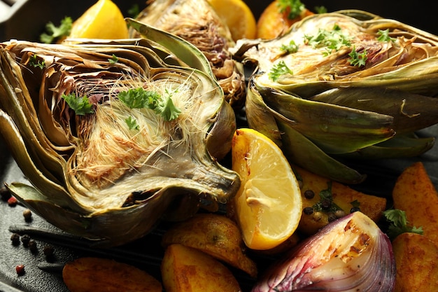 Concept of tasty food with grilled artichoke close up