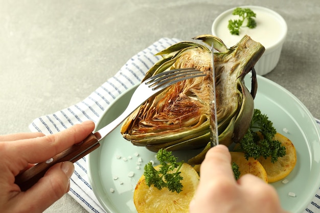 Concept of tasty food with grilled artichoke close up