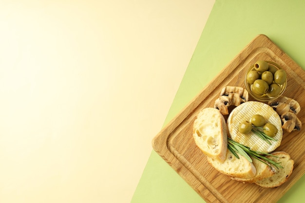 Concept of tasty food with grilled camembert on two tone background.