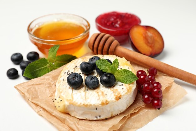 Concept of tasty food with grilled camembert on white background.