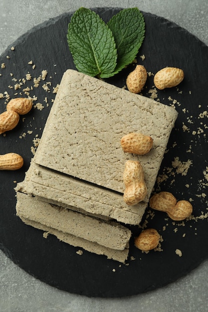 Concept of tasty food with halva on gray textured background