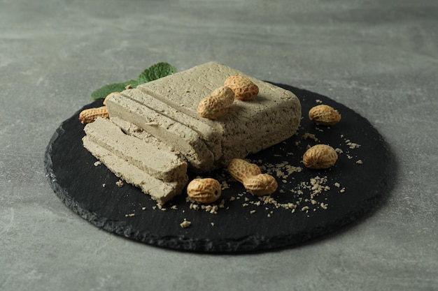 Concept of tasty food with halva on gray textured background