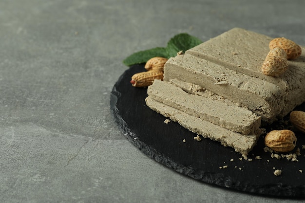 Concept of tasty food with halva on gray textured background